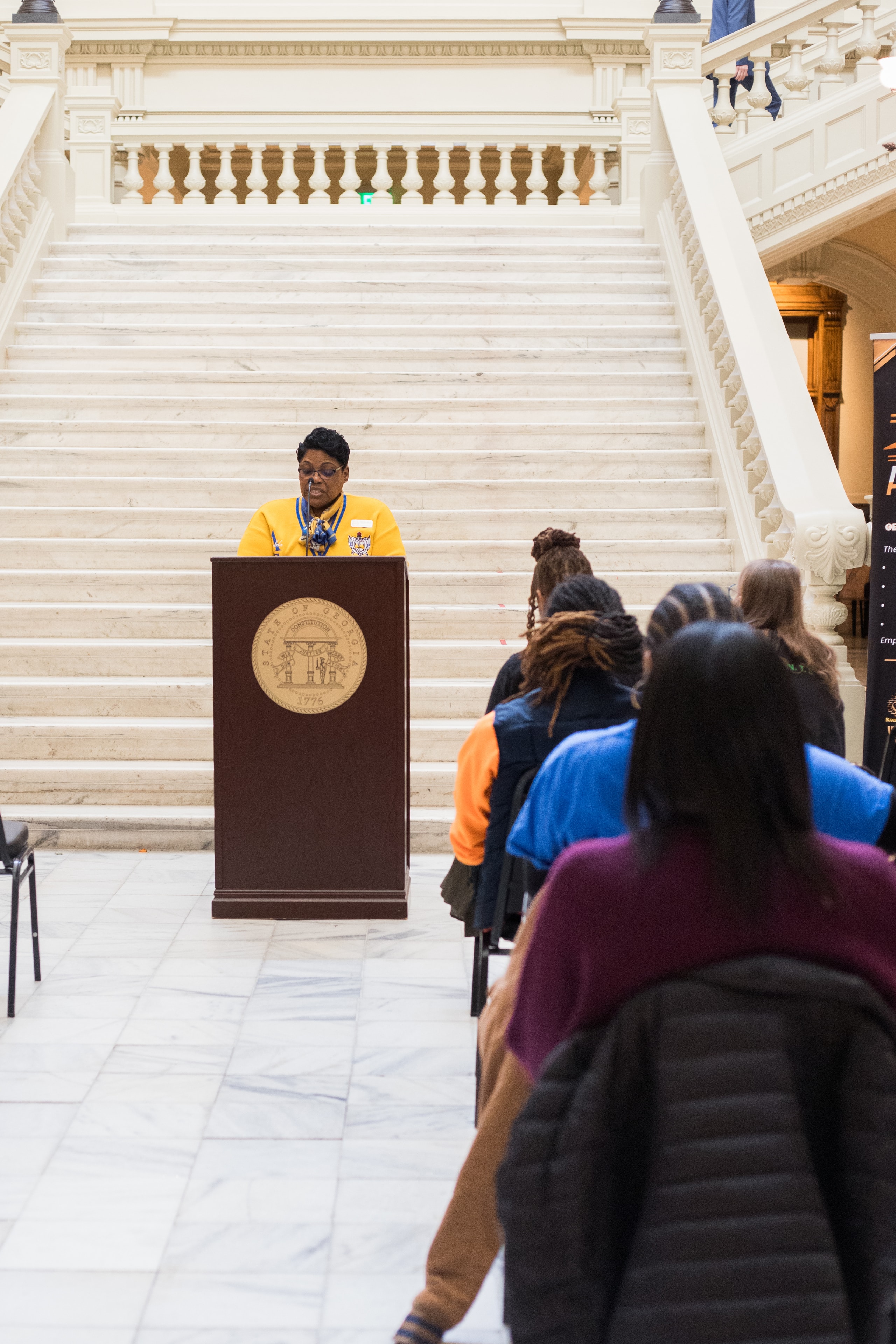Woman speaking at government building podium